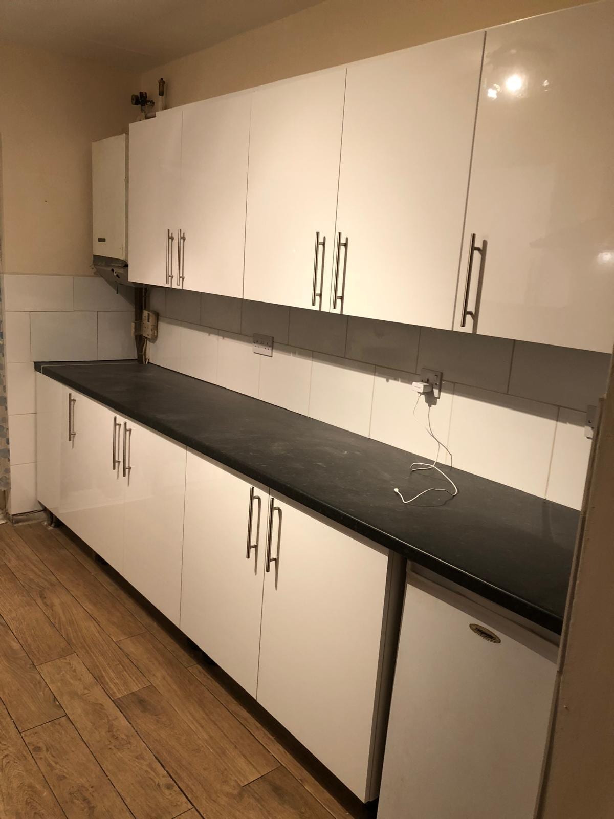 The same kitchen after a white cabinet refresh with new handles