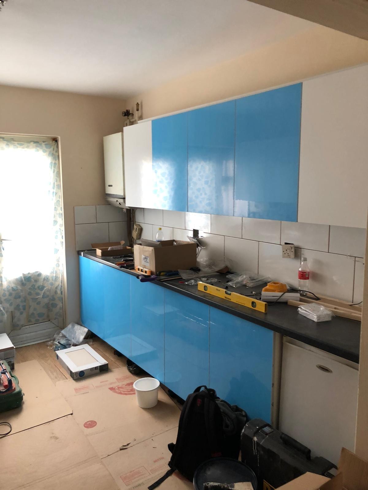 Blue gloss kitchen cabinetry before its professional refresh